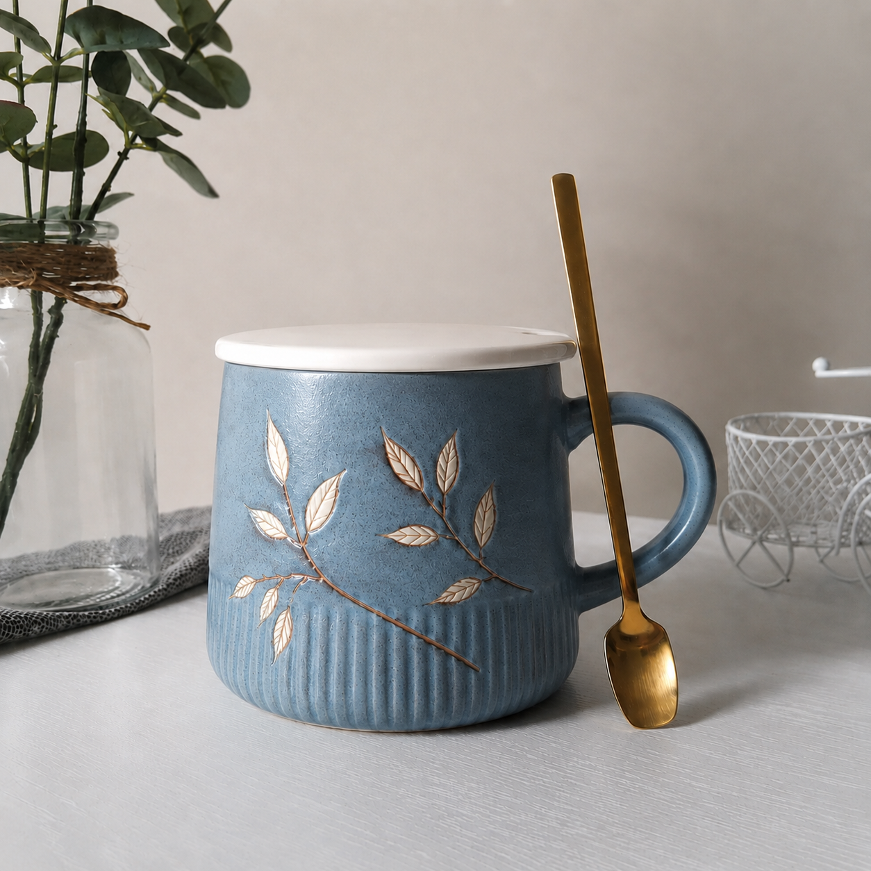 Premium dusty blue ceramic cup with an elegant botanical design.